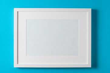 Frame for text on a blue background. Cardboard, paper, top view.