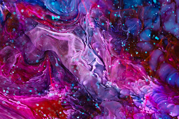 Fototapeta na wymiar Epoxy resin texture with pink, blue and red colors. Liquid backdrop with splashes and ripples. Modern abstract artwork with splatter inks. Bright colors mixes on macrophotography wallpaper