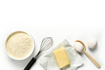 Flour, eggs, butter, whisk, spoon isolated on white background.