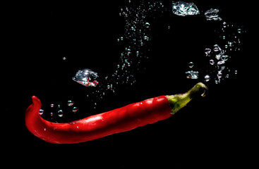 fresh red chilies with water bubbles. the concept of freshness of fruit in water. underwater...