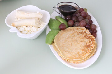 Homemade pancakes plus cottage cheese, and fruits 