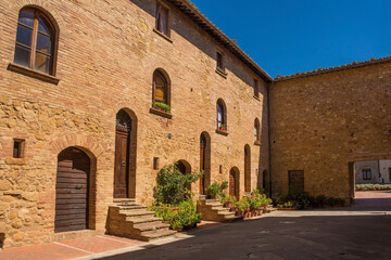 Fototapeta na wymiar An historic stone residential building in the village of Pienza in Siena Province, Tuscany, Italy 