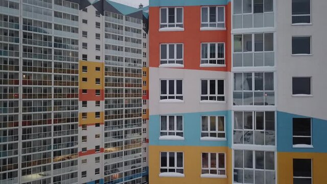 Drom slowly rises from bottom to top showing the windows of an apartment building