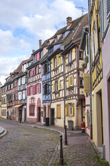 Fototapeta na wymiar Street scene with colorful traditional French houses in Colmar old town. Colmar is a charming town in Alsace. Colmar, France.