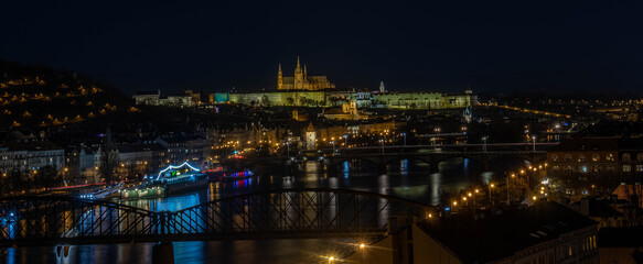 Fototapeta na wymiar Night cityscape of Prague with reflections on a river.