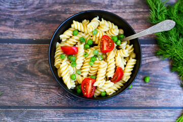 Home made vegetarian fusilli  pea  pasta with parmesan cheese and fresh dill  . Healty vegetarian meal