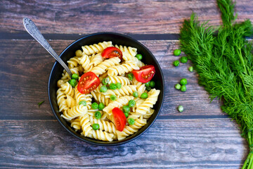 Home made vegetarian fusilli  pea  pasta with parmesan cheese and fresh dill  . Healty vegetarian meal