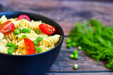 Home made vegetarian fusilli  pea  pasta with parmesan cheese and fresh dill  . Healty vegetarian meal