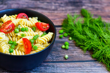 Home made vegetarian fusilli  pea  pasta with parmesan cheese and fresh dill  . Healty vegetarian meal