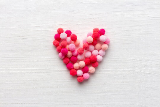 Fluffy heart as symbol of love on white wooden background for Mother day or St Valentine day
