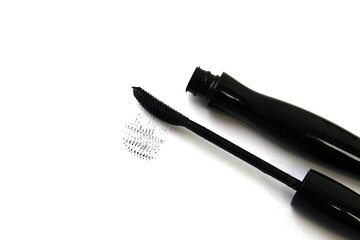 Black mascara lies on a white background