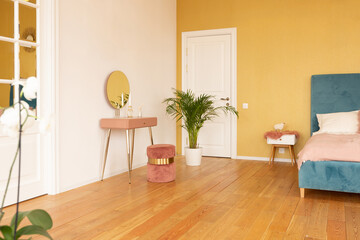 Fototapeta na wymiar Scandinavian style apartment interior. bright yellow warm colors. wooden flooring. sunlight in large windows.