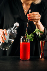 Closeup on making bloody mary cocktail with celery stalk