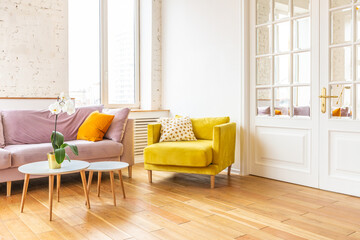 Scandinavian style apartment interior. bright yellow warm colors. wooden flooring. sunlight in large windows.