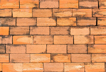Orange color brick wall for brickwork background design