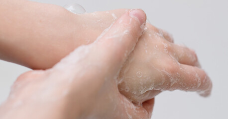 Fototapeta premium baby hands in foam, hand hygiene