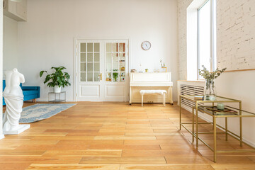 the interior of the study in the style of a loft. Brick wall. wooden flooring. large bright room with a seating area. sofa and piano