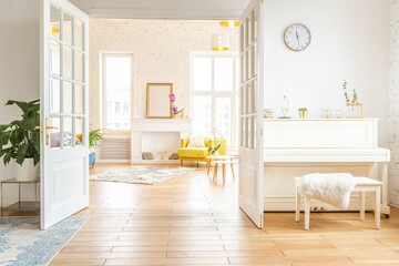 very light and sparcious two-rooms apartment in scandinavian design style with fashion furniture and large windows. warm colors during day time