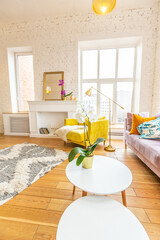 Scandinavian style apartment interior. bright yellow warm colors. wooden flooring. sunlight in large windows.