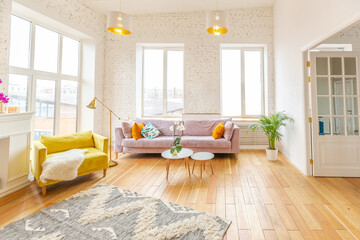 Scandinavian style apartment interior. bright yellow warm colors. wooden flooring. sunlight in large windows.