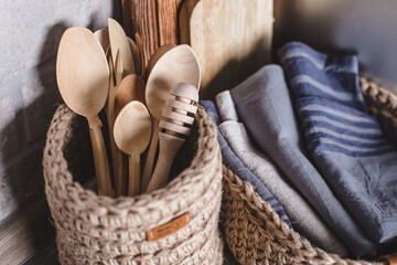 Eco friendly wooden cutlery set in jute knitted baskets. Zero waste concept. Decor and interior