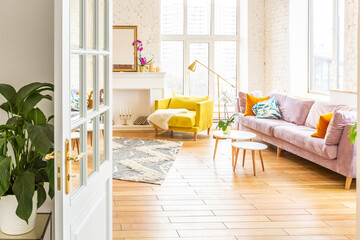 Scandinavian style apartment interior. bright yellow warm colors. wooden flooring. sunlight in large windows.