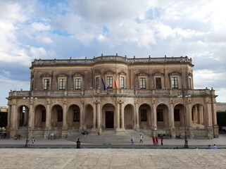 Fototapeta na wymiar The facade of the town hall of the city of Noto in Sicily in late Baroque style