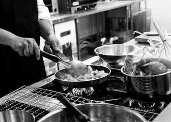 Chef cooking in a kitchen, chef at work, Black and White.