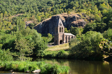 Beautiful countryside landscape with an old church on the edge of a river.