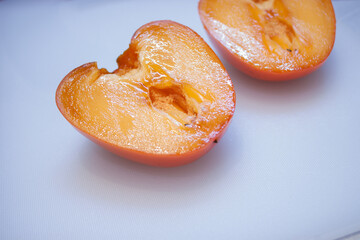 fresh ripe persimmons with slices of persimmon isolated on white background. clipping path.