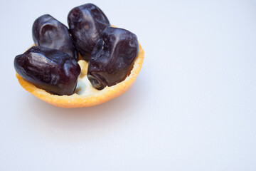 Bowl of dried dates isolated on white background