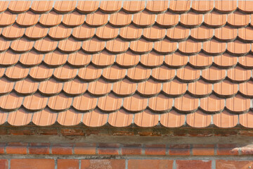 Old red clay tiles on roof close-up. Selective focus, vintage background