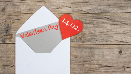 Valentine's day greeting card concept banner. Envelope, card and red heart on rustic wooden wood table texture background top view. Flat lay.