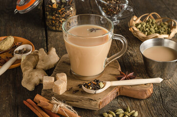 Masala tea with spices on a wooden background, a warming drink