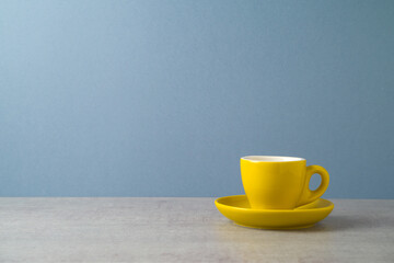 Yellow coffee cup over gray background. Modern kitchen mock up for design