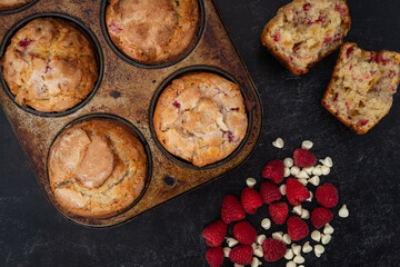 Freshly baked Raspberry White Chocolate Muffins Cooling on the counter