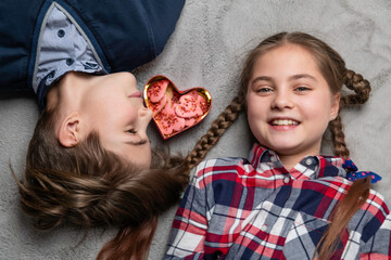 girl and boy snacking on heart-shaped cookies together
