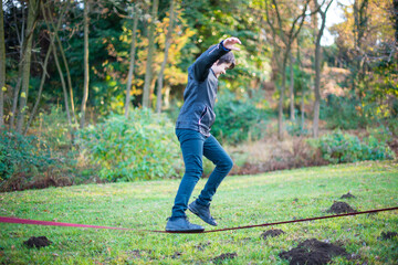 12 year old boy walks on rope slackline