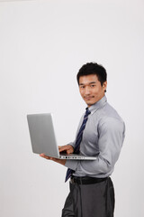 A young business man using a laptop