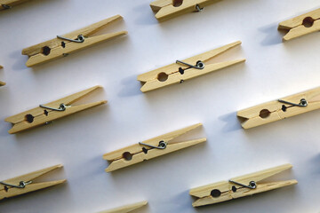 Wooden clothes pegs on white background. Top view. 