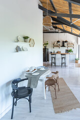 stylish kitchen interior design. white walls and wooden decoration. beautiful hammock and high windows.