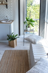stylish kitchen interior design. white walls and wooden decoration. beautiful hammock and high windows.