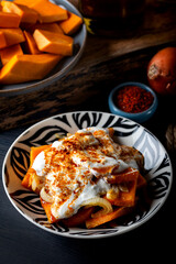 Traditional Aegean meal Sinkonta is made with pumpkin on the dark background. 