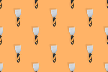 Putty trowel seamless pattern. Spatulas for on an orange background.