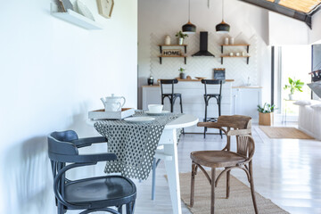 stylish kitchen interior design. white walls and wooden decoration. beautiful hammock and high windows.