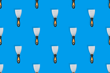 Putty trowel seamless pattern. Spatulas for a blue background.