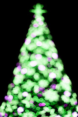 Isolated beautiful blurred street sparkles from lights of the christmas tree on dark bacground.