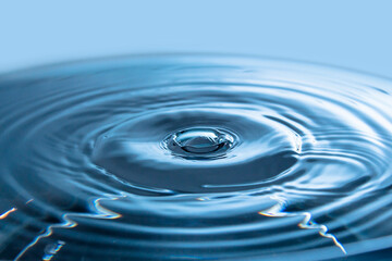Water splash backgrounds close-up.Crown of blue water.Water drop.Frozen splashing in motion.Slow dripping of liquid with air bubbles. Nature backgrounds or Wallpaper.Frozen liquid splashes