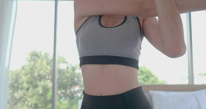 Body close up Asian woman stretching muscle warm up workout weight training and yoga exercise at home in sexy sportswear. Take care health in quarantine coronavirus with new normal social distancing