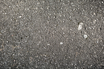 gray, old asphalt with white patches. close-up.